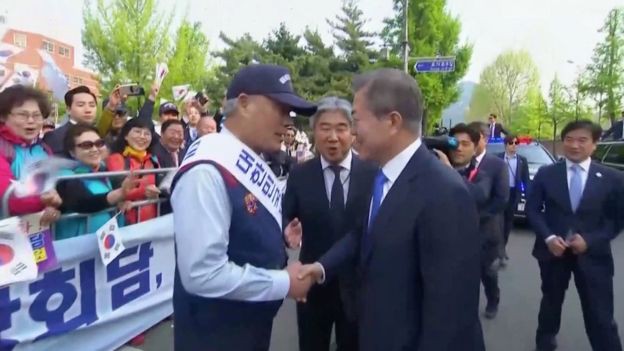 Screen grab of South Korean President Moon Jae-in shaking hands in Seoul, as he makes his way to the inter-Korean summit. April 27, 2018