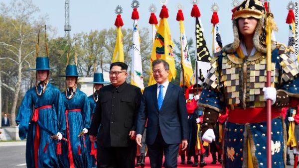 North Korean leader Kim Jong Un, left, and South Korean President Moon Jae-in walk togetherÂ after he crossed into the southern side of the DMZ.