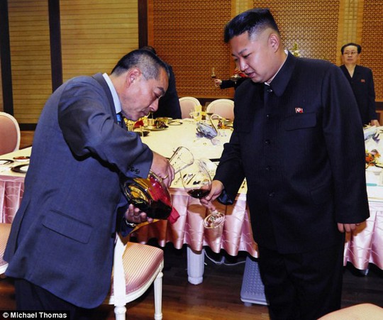 Like old times: Kenji Fujimoto pours wine for Kim Jong Un during their reunion in 2012, burgundy red is not the North Korean dictators favorite, although he used to down bottles of vodka from his early teens