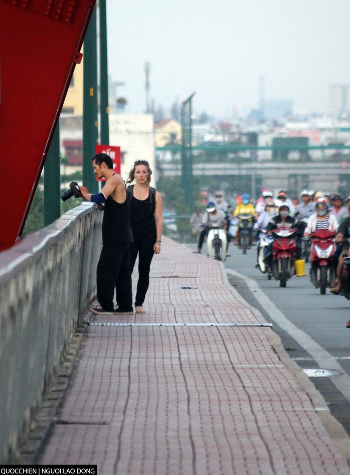 
Chàng trai mạo hiểm chinh phục cầu Bình Lợi cho bạn gái quay phim, chụp ảnh.
