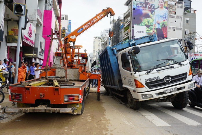 Giải cứu xe rác bị sụp hố sâu trên đường Hai Bà Trưng - Ảnh 2.