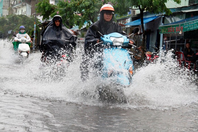 Người dân TP HCM bì bõm sau cơn mưa lớn - Ảnh 1.