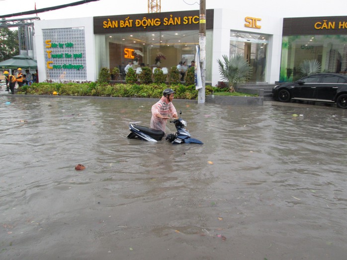 TP HCM: Nước ngập đến yên xe sau cơn mưa chiều cuối tuần - Ảnh 1.