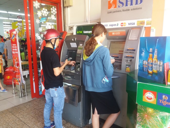 Chật vật rút tiền từ máy ATM ngày cận Tết - Ảnh 1.