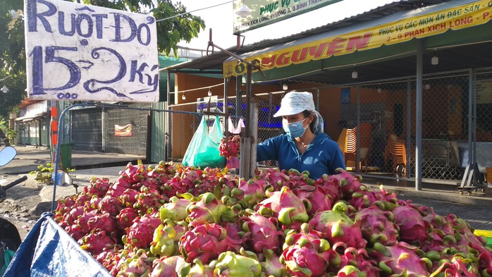 Còn 15.000 đồng/2kg, thanh long lại đổ đống, bán đầy đường TP HCM - Ảnh 1.