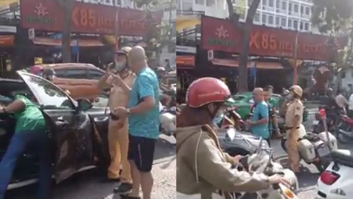 VIDEO: Hai người đàn ông đi ôtô chửi bới, văng tục CSGT TP HCM - Ảnh 2.