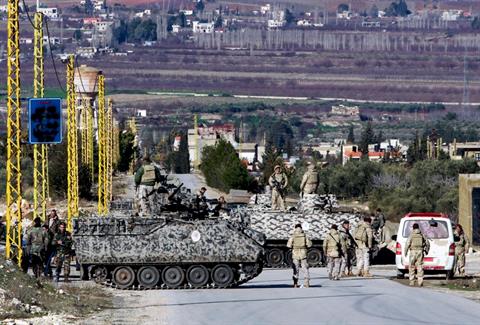 File photo of Lebanese soldiers searching civilians at a checkpoint at the entrance of Arsal. AP Photo/Bilal Hussein)