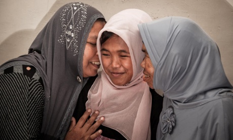 Raudhatul Jannah is hugged by her mother Jamaliah, left, and grandmother after they were reunited in Meulaboh, Aceh, Indonesia,