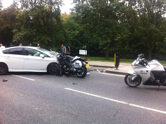 Pictures taken in the aftermath of the accident in central London show the police motorbike embedded in the white Toyota Prius, as the driver lies slumped in his seat surrounded by deployed airbags