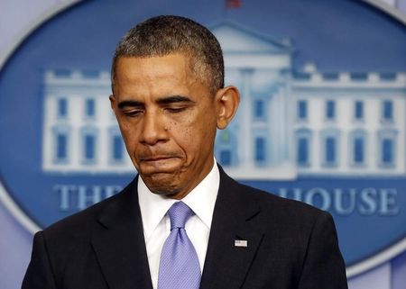 U.S. President Obama pauses while he talks about the Affordable Care Act at the White House in Washington