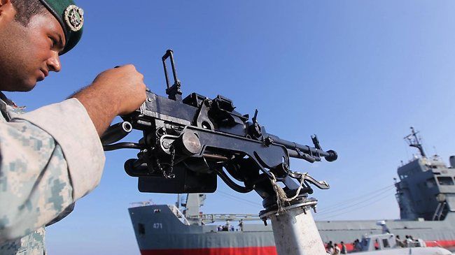 An Iranian Army soldier stands guard on a military speed boat during naval exercises in the Strait of Hormuz. (File photo)