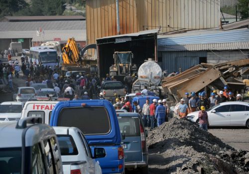 Rescue workers at the entrance of the mine after an explosion and fire at a coal mine in Soma, in western Turkey, Tuesday, May 13, 2014.  An explosion and fire at a coal mine in western Turkey killed at least one miner Tuesday and left up to 300 workers trapped underground, a Turkish official said. Twenty people were rescued from the mine in the town of Soma in Manisa province but one later died in the hospital, Soma administrator Mehmet Bahattin Atci told reporters. The town is 250 kilometers (155 miles) south of Istanbul.  TURKEY OUT Photo: IHA, AP / IHA