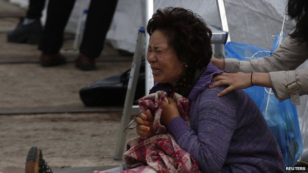 A relative of one of the missing passengers cries in Jindo