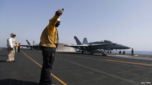 A F/A-18C Hornet takes off from an aircraft carrier