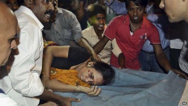 An injured woman is carried on a stretcher to a hospital for treatment in Patna, India, on 3 October 2014