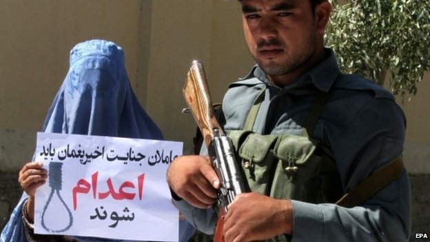 An Afghan woman holds a placard reading in Darri Be executed during a protest against a high-profile gang rape case that shocked the capital Kabul, in Herat, Afghanistan, 08 September 2014