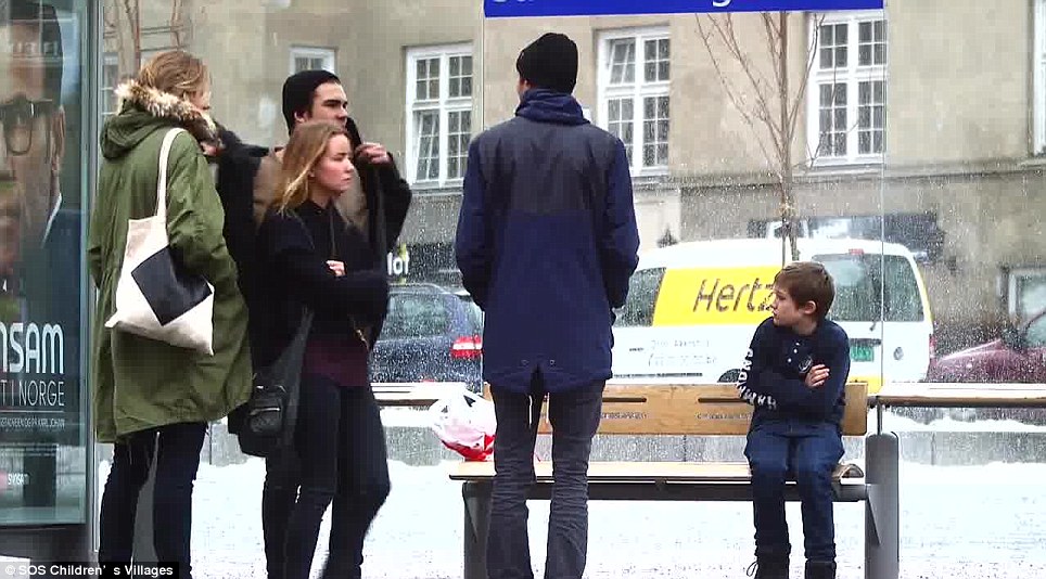 This group of people tried to help the boy out of his predicament. The man in the black hat was one of dozens who handed over warm clothing