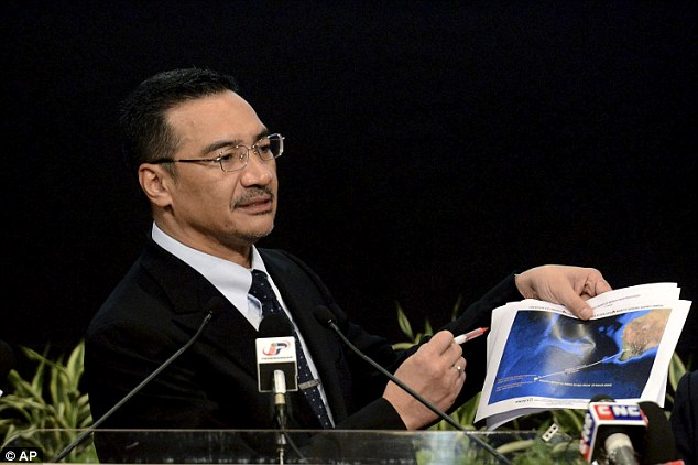 Breakthrough: Malaysias Defense Minister and acting Transport Minister Hishammuddin Hussein shows a printout of the latest satellite image of objects that might be from the missing Malaysia Airlines plane