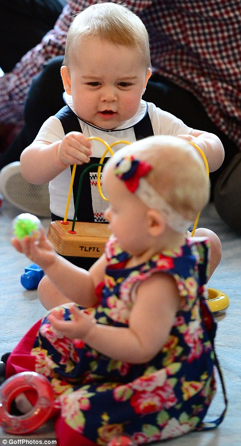 George looked a tad bemused as he inspected his toy while one of his playmates gazed with equal perplexity at hers