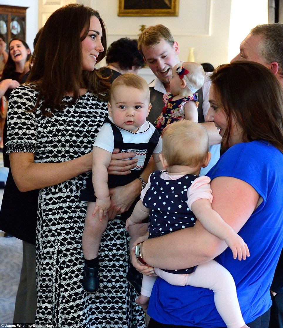 Kate mingled with the other first-time parents, holding her son, who was dressed in a pair of navy blue dungarees, in her arms