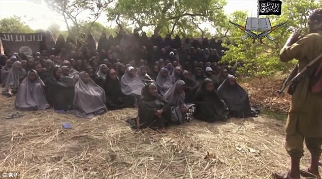 A still taken from a video by Nigeria&apos;s Boko Haram terrorist network shows the missing girls. A top Nigerian military official says the authorities know where the girls are, but cannot move in over fears for their safety