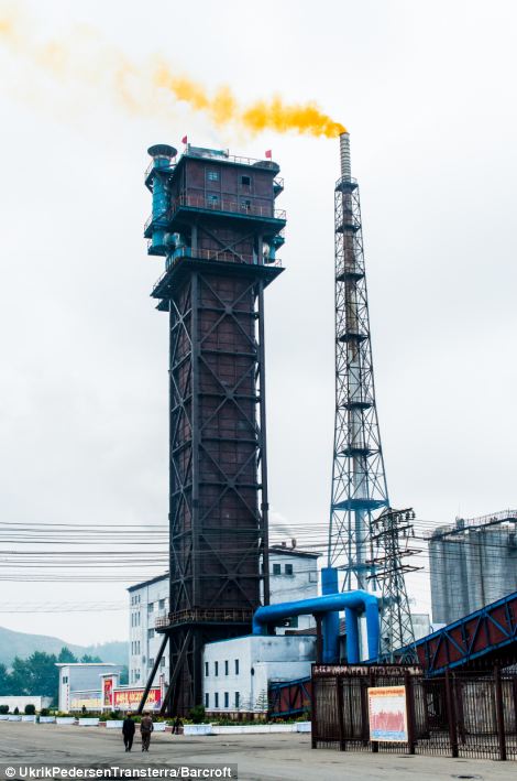 Yellow smoke billows from a factory chimney in Hamhung