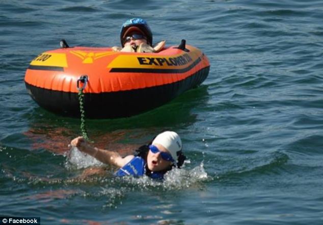 Show of strength: Noah Aldrich, 8, is pictured pulling his six-year-old brother Lucas during a triathlon