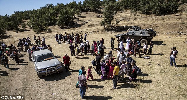 On the run: Yazidi Iraqis cross into the mountains of North Kurdistan after escaping ISIS from Mount Sinjar following U.S. air strikes. The residents of Amerli are campaigning for a similar rescue plan from the West