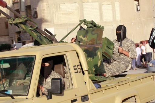 File: A knife wielding Islamic State militant sits at the helm of an anti-aircraft gun. Reuters