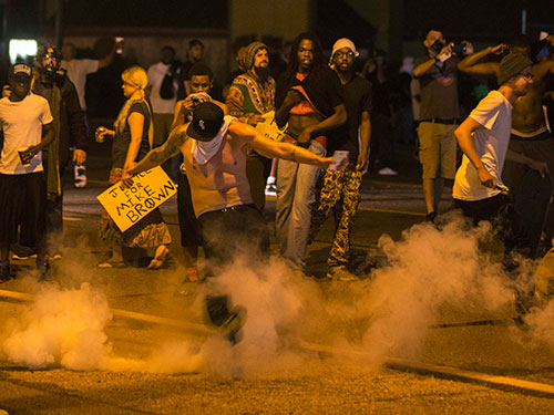 Người biểu tình đụng độ với cảnh sát tại TP Ferguson  hôm 17-8 Ảnh: Reuters