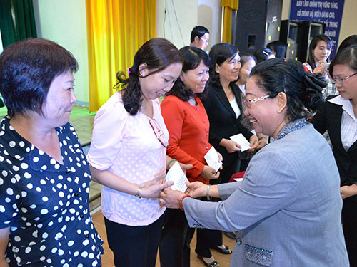 Bà Nguyễn Thị Thu Thảo, Phó Ban Nữ công LĐLĐ TP HCM, trao quà cho nữ CNVC-LĐ đạt danh hiệu phụ nữ hai giỏi Ảnh: HỒNG NHUNG