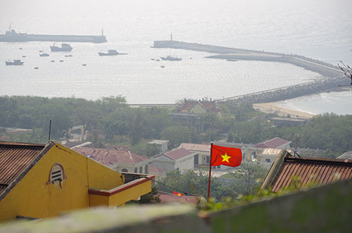 Cờ Tổ quốc tung bay trên đảo nhìn từ điểm cao nhất của đảo Bạch Long Vĩ về phía âu cảng