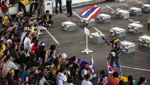 Anti- government protesters sit inside a district office next to election boxes which are to be delivered to polling stations, just before the beginning of voting hour in central Bangkok, on Sunday, Feb 2, 2014. Anti-government protesters blocked voting in dozens of constituencies in tense Thai elections on Sunday overshadowed by pre-poll bloodshed, an opposition boycott and fears of protracted political limbo. -- PHOTO: REUTERS