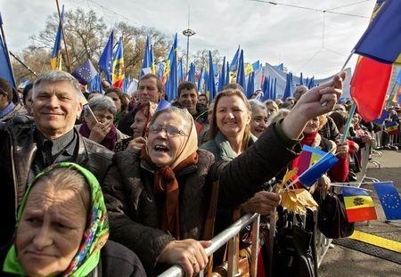 People wave EU and Moldavian national flags, and shout slogans, during a pro-EU rally in Chisinau,