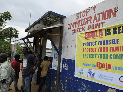 Binh sĩ kiểm tra người dân đi lại ở Bomi - Liberia trong nỗ lực ngăn chặn virus Ebola lây lan Ảnh: Reuters