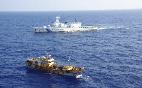 Tàu bảo vệ bờ biển Nhật Bản (phía trên) đón đầu một tàu Trung Quốc săn trộm hồi năm ngoái. Ảnh: Reuters