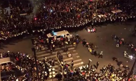 An ambulance comes to the aid of people caught up in the stampede in Shanghai