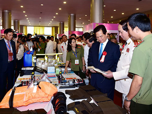 Thủ tướng Nguyễn Tấn Dũng cùng các đại biểu tham quan khu trưng bày sản phẩm của các đơn vị công an sản xuất Ảnh: NHẬT BẮC