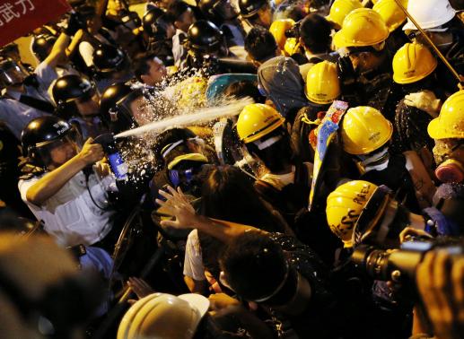 Police use pepper spray during clashes with pro-democracy protesters close to the chief executive office in Hong Kong in this November 30, 2014 file photo.  REUTERS-Tyrone Siu-File