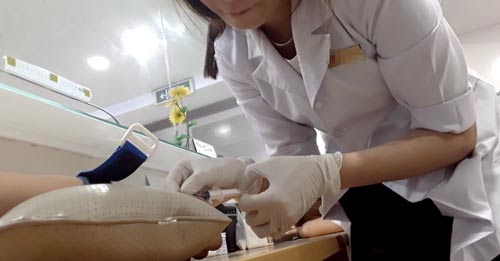 Y tá Phòng khám Đa khoa Thế Giới đang lấy máu của phóng viên để xét nghiệm Ảnh: YÊN PHÚ