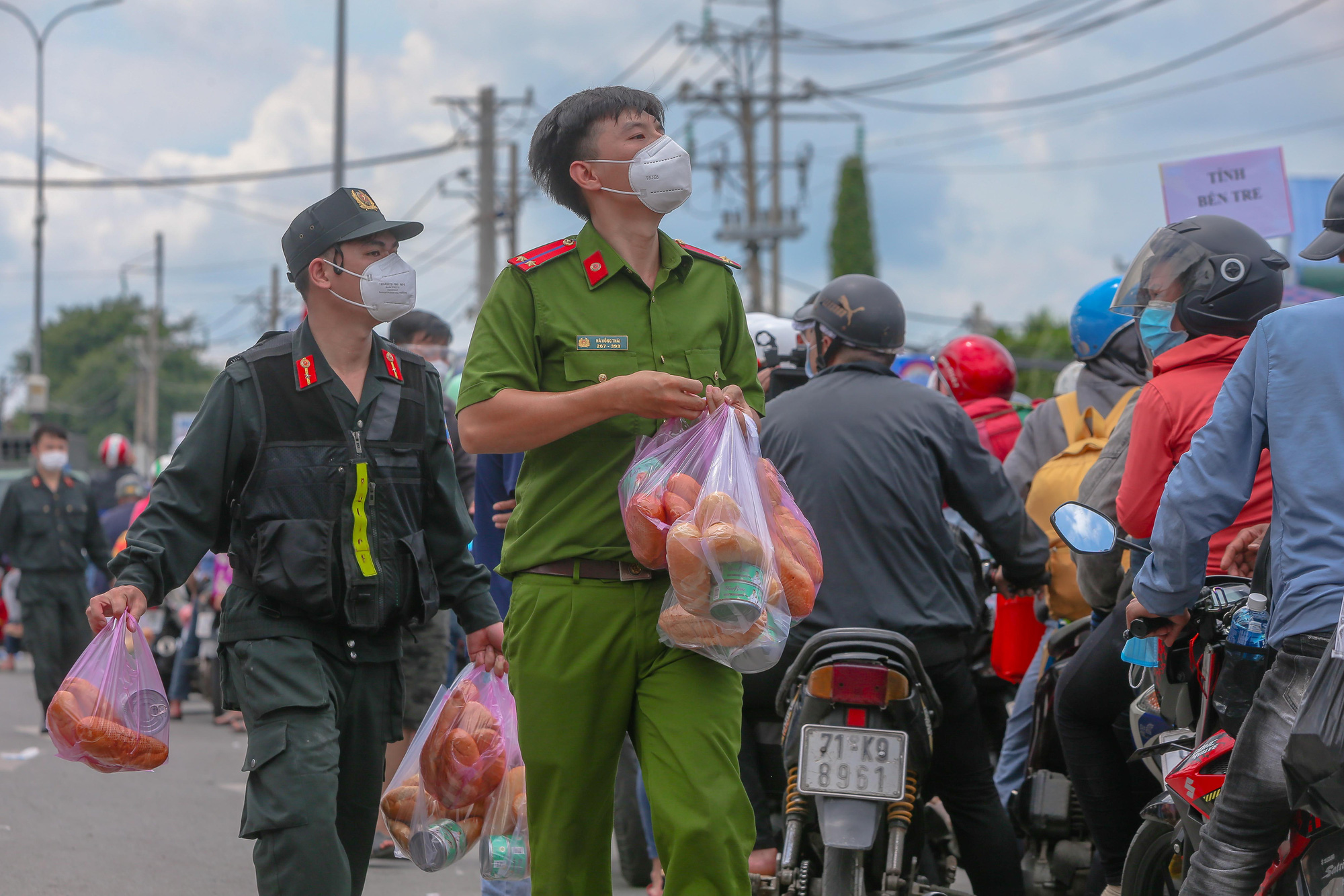 Quân đội, công an tặng thực phẩm, nước uống cho người dân trước khi rời TP HCM về quê - Ảnh 2.