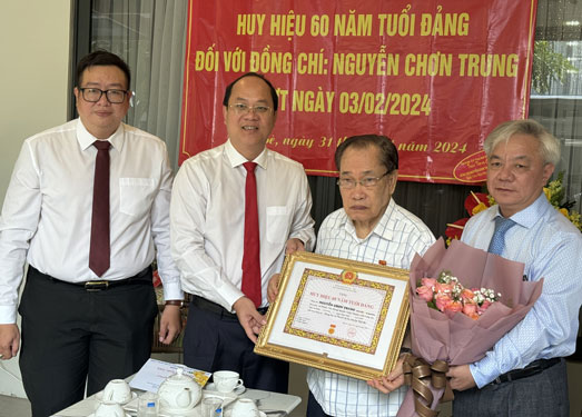 Phó Bí thư Thường trực Thành ủy TP HCM Nguyễn Hồ Hải trao Huy hiệu 60 năm tuổi Đảng cho ông Nguyễn Chơn Trung