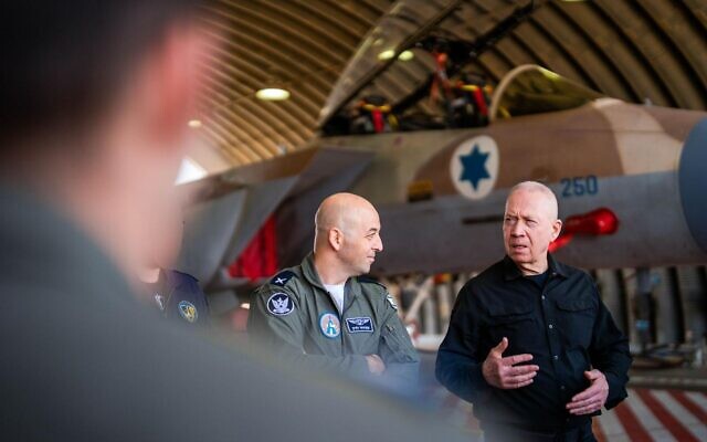 Defense Minister Yoav Gallant (right) speaks to Israeli Air Force pilots and crews at the Hatzerim Airbase, October 23, 2024. (Ariel Hermoni/Defense Ministry)