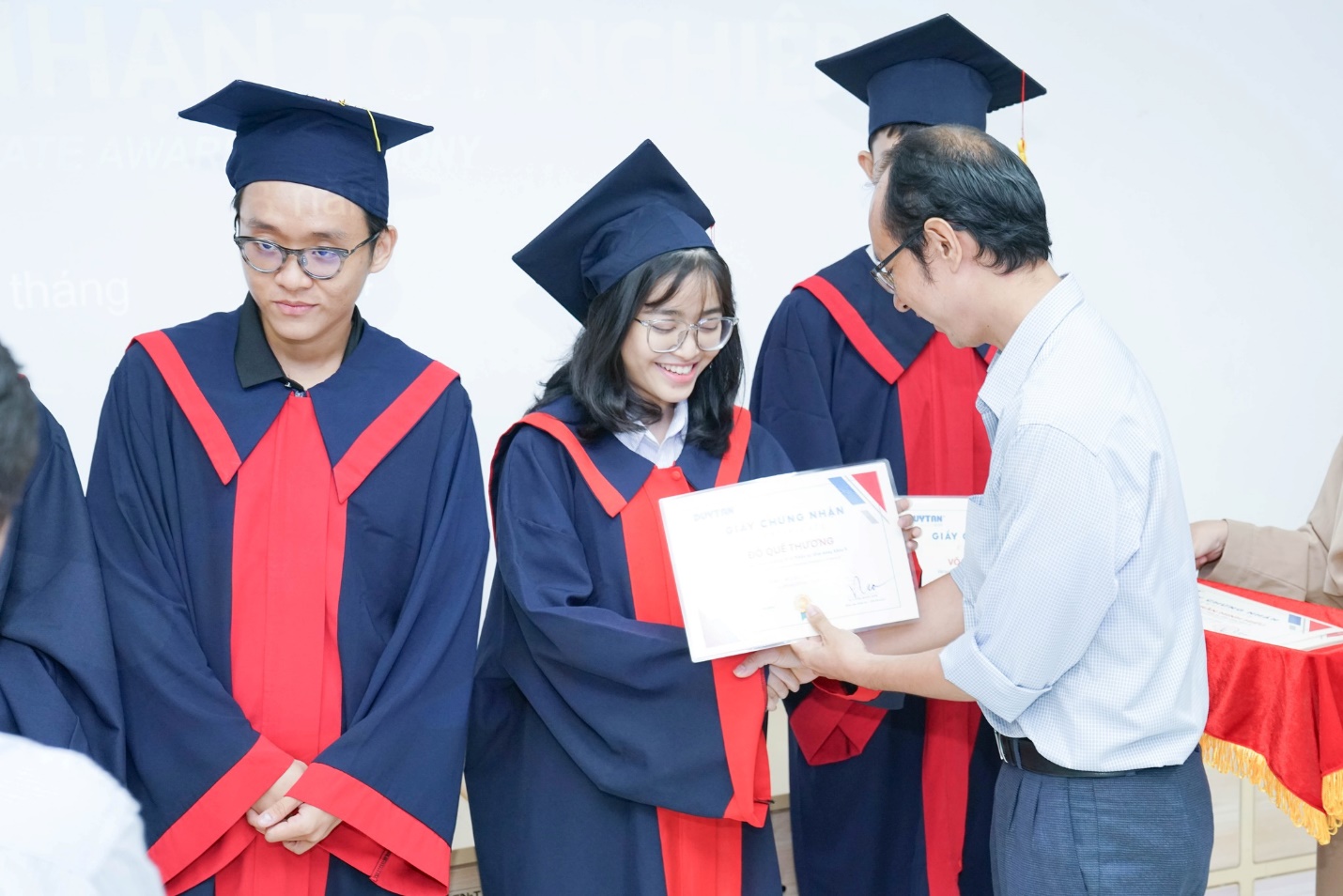 A group of people in graduation gowns  Description automatically generated