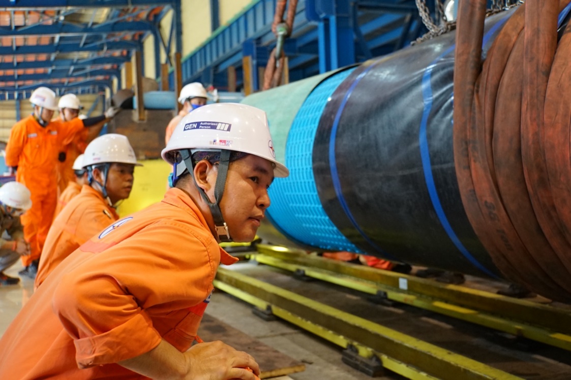 A group of men wearing hard hats  Description automatically generated