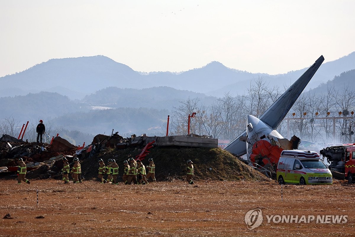 Firefighters carry out rescue operations at Muan International Airport in Muan, 288 kilometers southwest of Seoul, on Dec. 29, 2024, after a passenger plane with 181 people aboard crashed. (Yonhap)