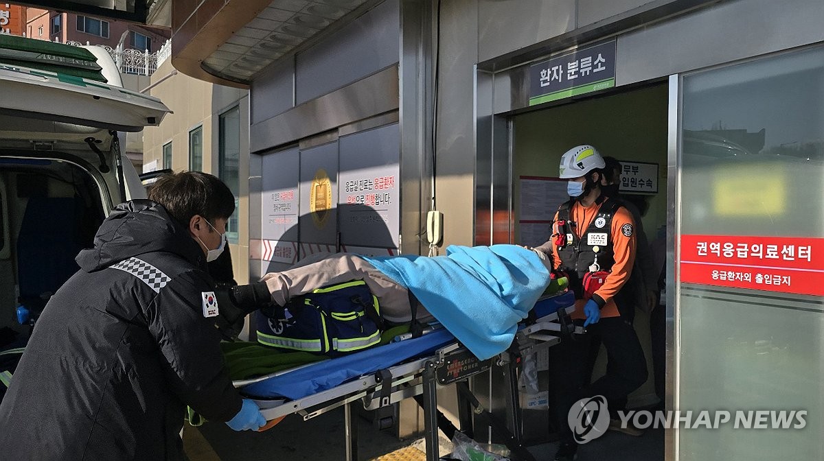 A passenger rescued from the plane crash at Muan International Airport in Muan, South Jeolla Province, is transported to a hospital in Mokpo, a city in the same province, on Dec. 29, 2024. (Yonhap) 