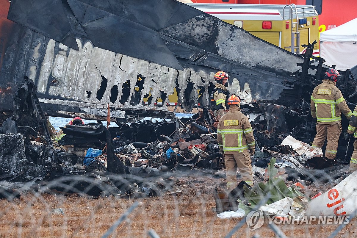 Firefighters carry out search operations at Muan International Airport in the southwestern county of Muan on Dec. 30, 2024, after a Jeju Air passenger plane with 181 people aboard crashed the previous day. (Yonhap)