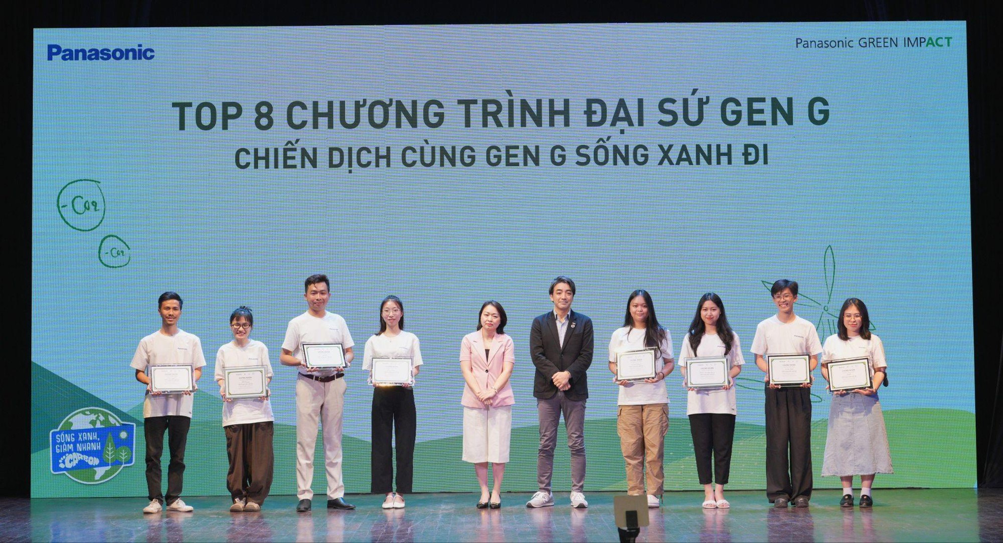A group of people standing on a stage  Description automatically generated
