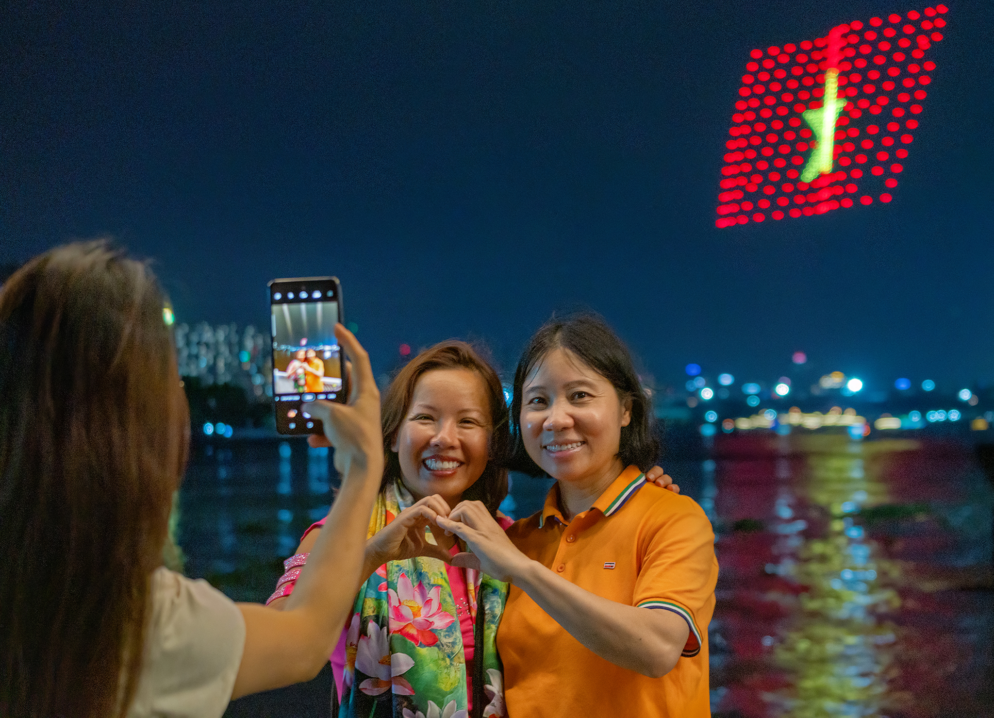 Du khách thích thú chụp hình với màn trình diễn của drone light trên sông